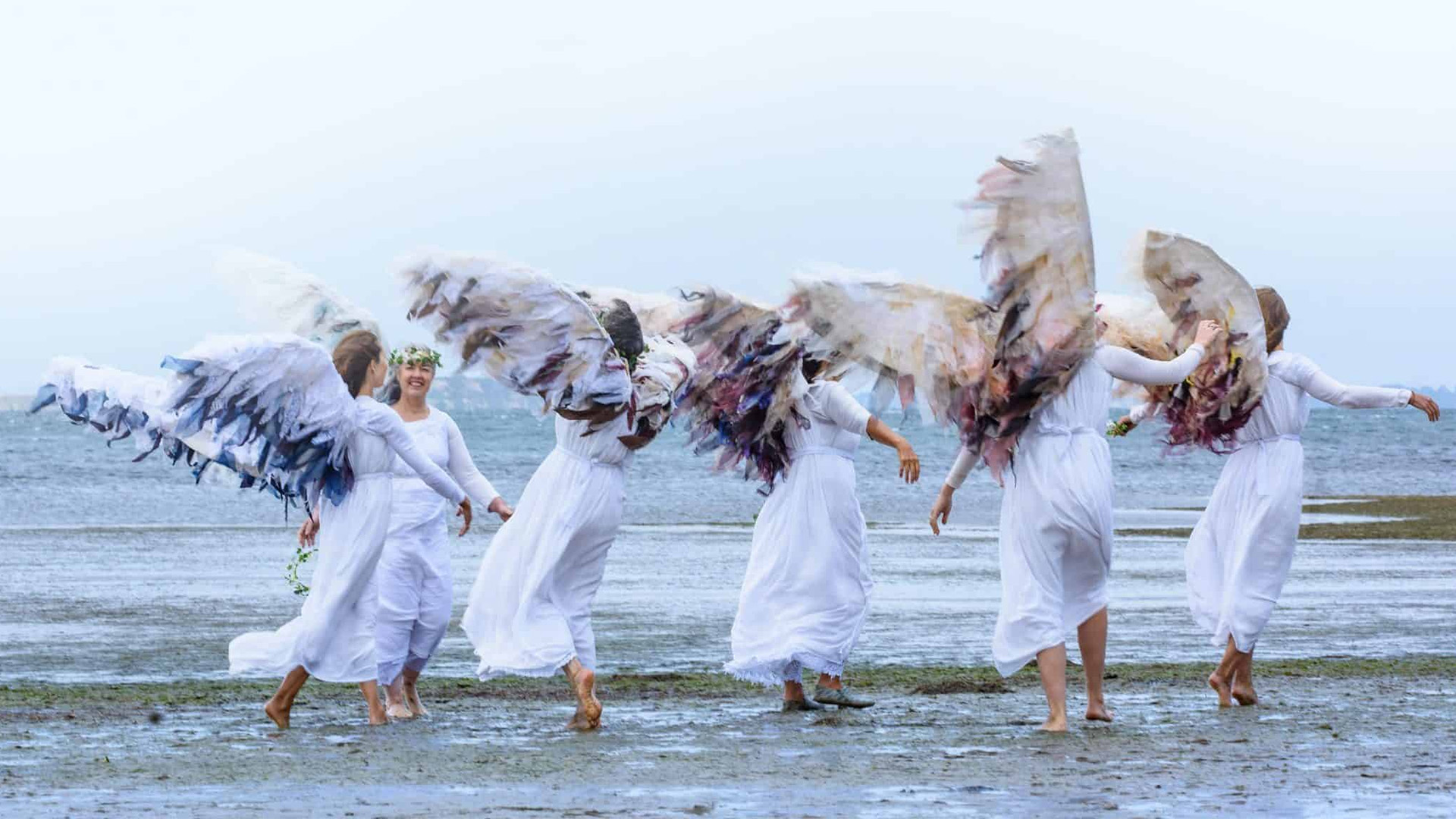 Women dressed as angels performing as Climate Guardians for the NGO ClimActs.