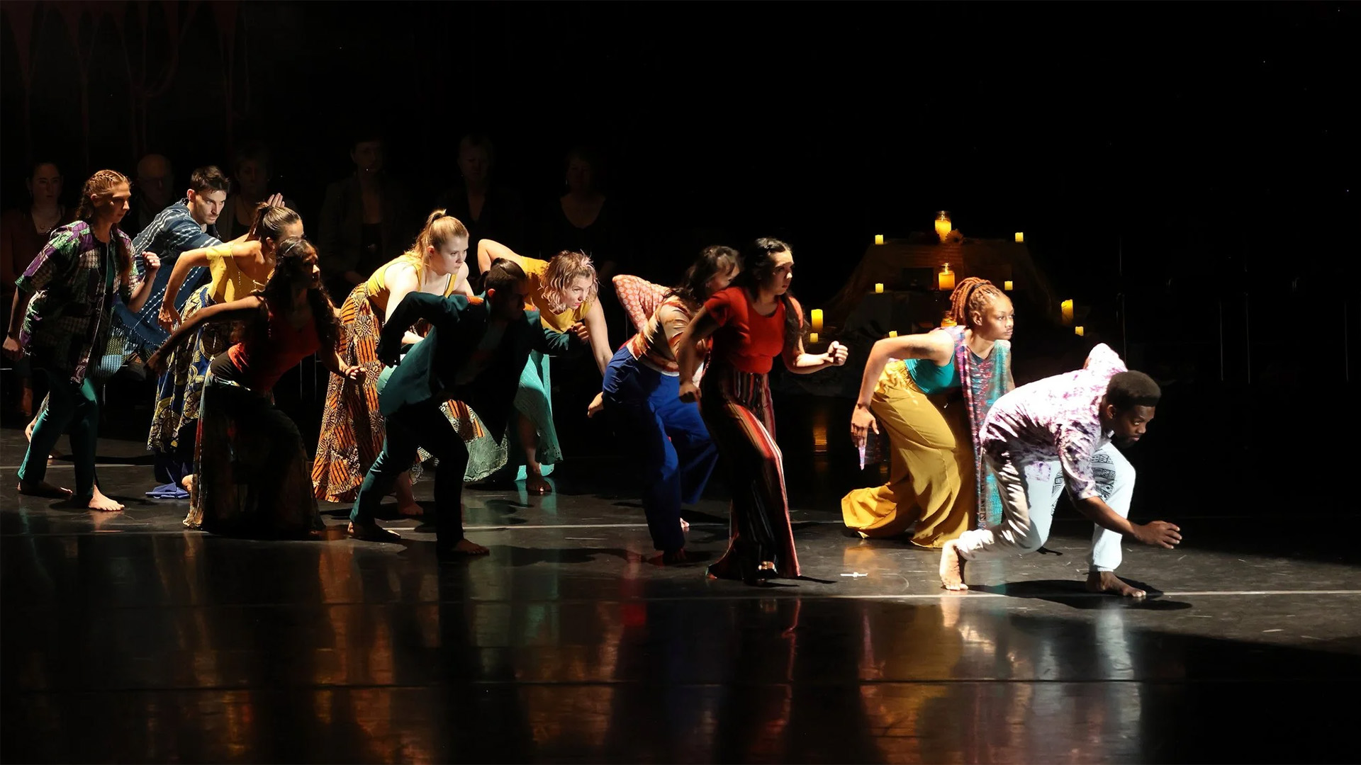 Dancers performing "joyUS justUS" in front of an audience.