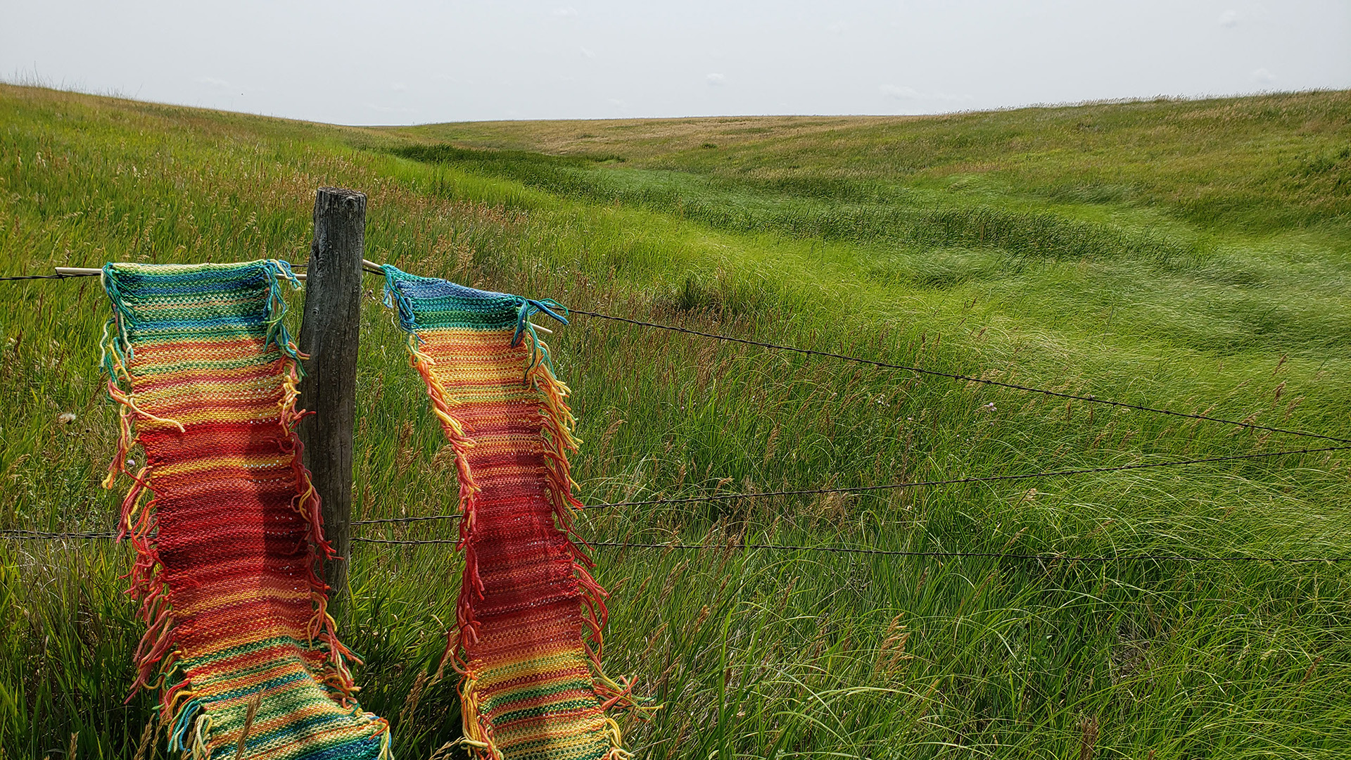 Hand-knit tapestry by Karen Poremski from the Tempestry Project, showing temperature stripes over years for Fort Pierre National Grassland, turning climate data into visual fiber art.