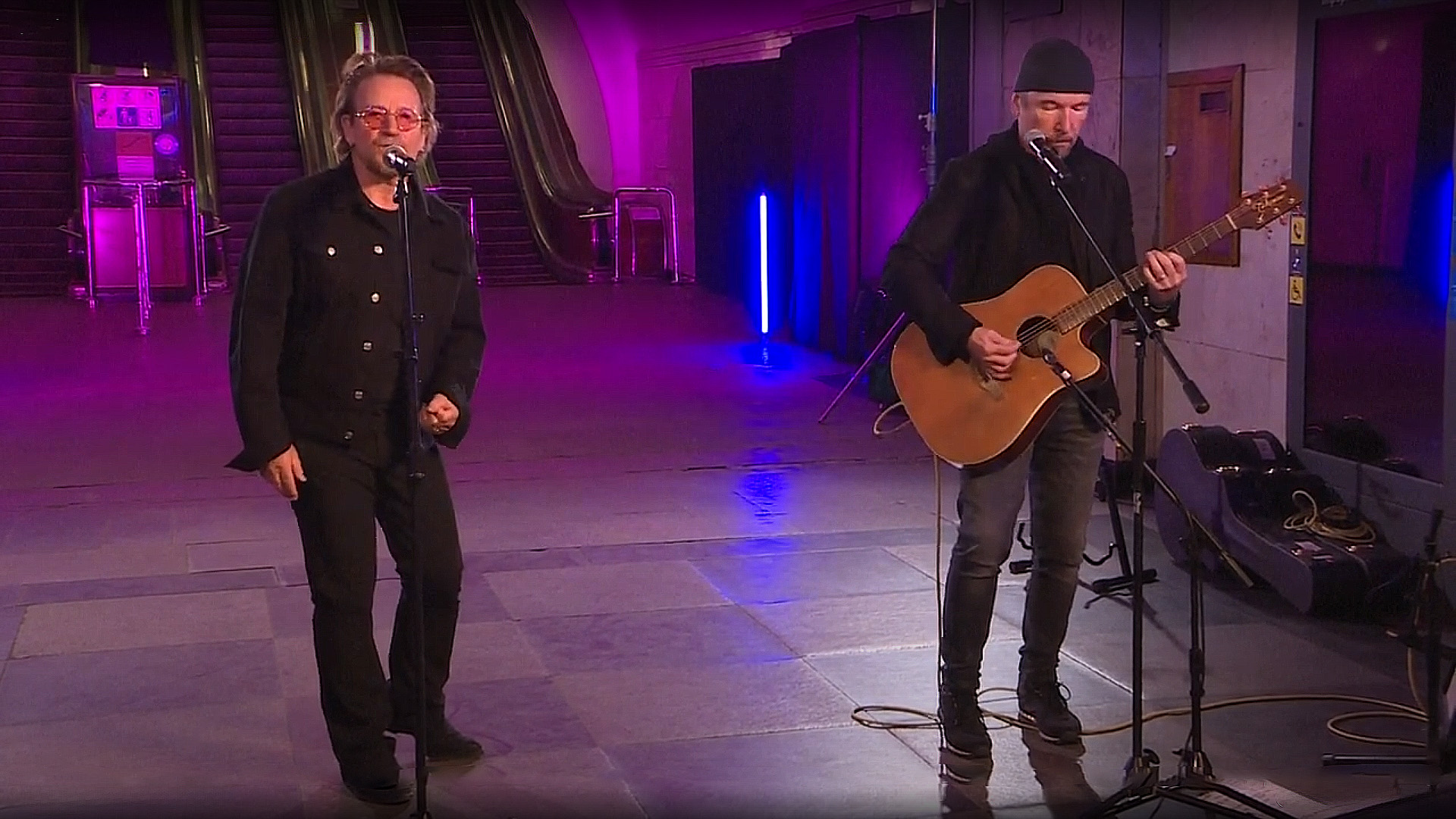 Bono and The Edge of U2 performing an impromptu acoustic set in a Kyiv metro station bomb shelter, spreading hope and solidarity amid conflict.